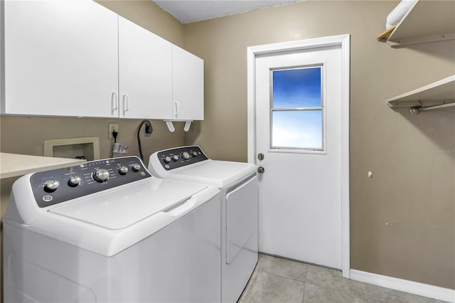 7461 Pescador Pl, Seminole, FL 33772 - washroom with independent washer and dryer, cabinet space, baseboards, and light tile patterned floors