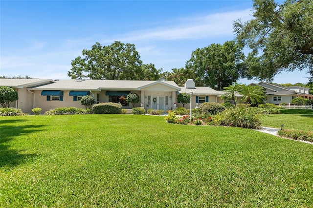 2110 Reaney Rd, Lakeland, FL 33803 - ranch-style home featuring a front lawn and a chimney