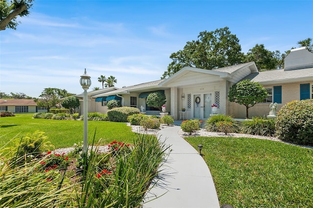 2110 Reaney Rd, Lakeland, FL 33803 - single story home featuring a front lawn, brick siding, and covered porch