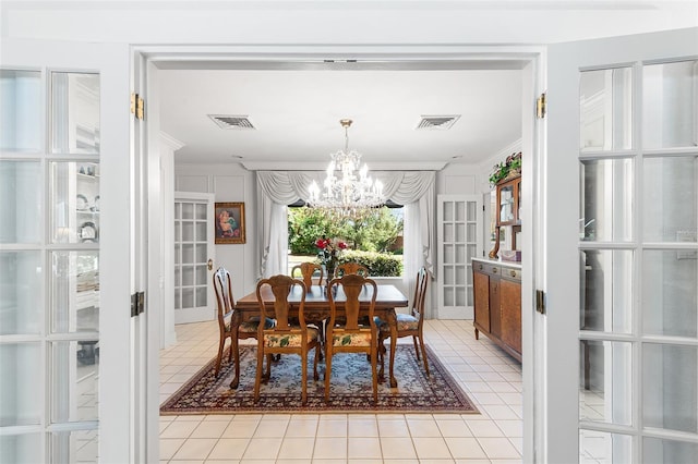 2110 Reaney Rd, Lakeland, FL 33803 - dining room with a chandelier, ornamental molding, light tile patterned floors, and french doors