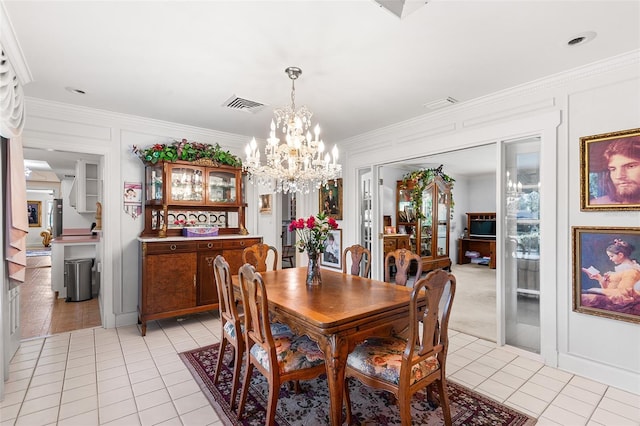 2110 Reaney Rd, Lakeland, FL 33803 - dining space featuring light tile patterned flooring, crown molding, and a chandelier