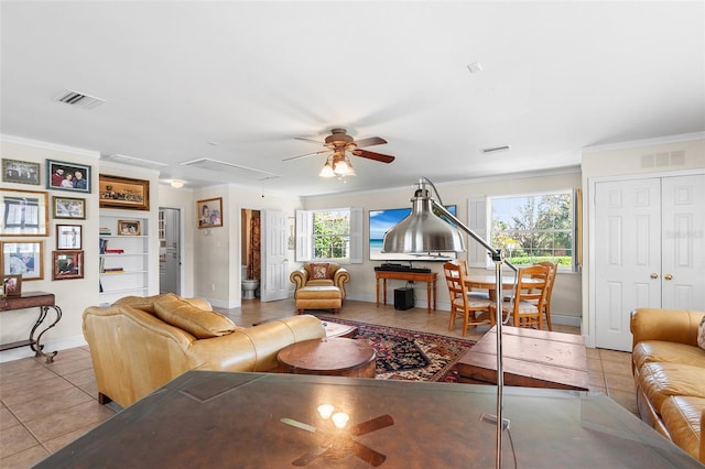 2110 Reaney Rd, Lakeland, FL 33803 - living area with attic access, tile patterned flooring, ceiling fan, baseboards, and crown molding