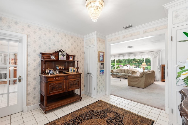 2110 Reaney Rd, Lakeland, FL 33803 - entrance foyer featuring light tile patterned floors, baseboards, a chandelier, and wallpapered walls