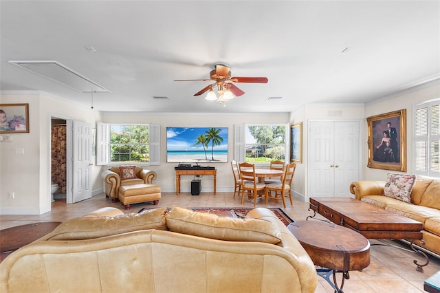 2110 Reaney Rd, Lakeland, FL 33803 - living area featuring attic access, light tile patterned floors, ceiling fan, baseboards, and crown molding