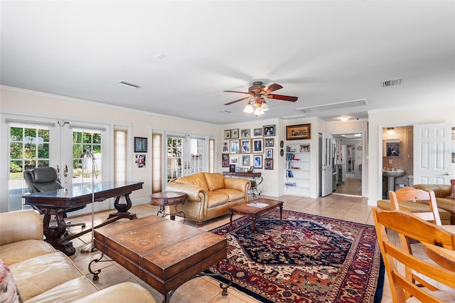 2110 Reaney Rd, Lakeland, FL 33803 - living area featuring french doors, attic access, ceiling fan, light tile patterned flooring, and crown molding