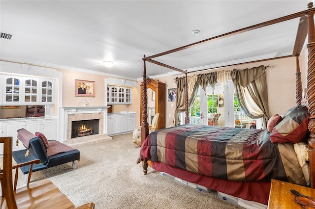 2110 Reaney Rd, Lakeland, FL 33803 - carpeted bedroom with crown molding, access to exterior, and a warm lit fireplace