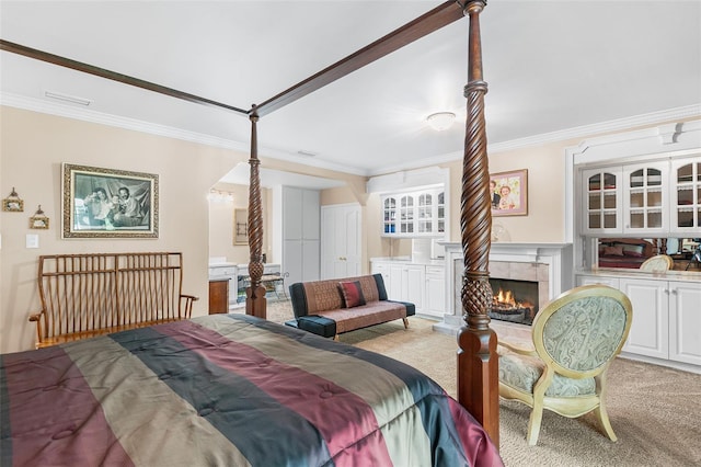 2110 Reaney Rd, Lakeland, FL 33803 - carpeted bedroom featuring crown molding and a tile fireplace