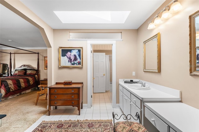 2110 Reaney Rd, Lakeland, FL 33803 - bathroom featuring a skylight, vanity, tile patterned flooring, ensuite bath, and baseboards