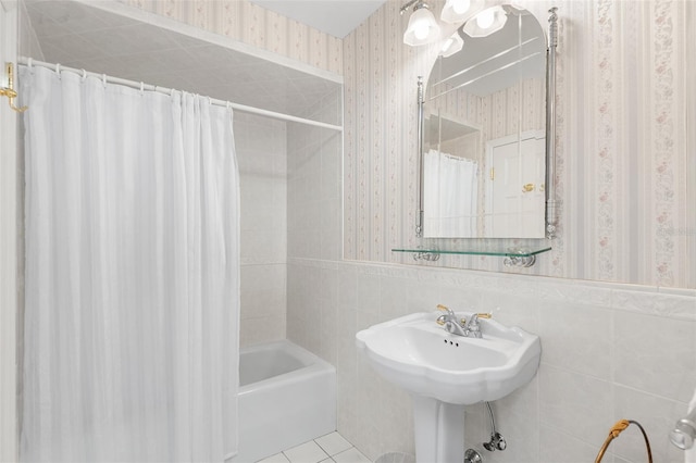 2110 Reaney Rd, Lakeland, FL 33803 - full bathroom featuring wallpapered walls, wainscoting, tile patterned floors, shower / tub combo, and tile walls