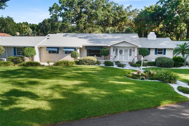 2110 Reaney Rd, Lakeland, FL 33803 - ranch-style home featuring a front yard and a chimney