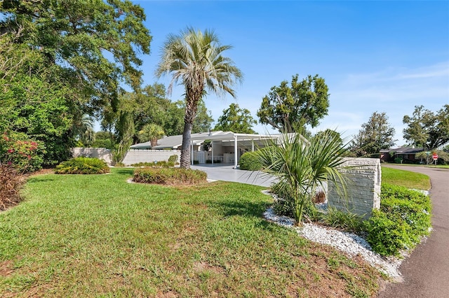 2110 Reaney Rd, Lakeland, FL 33803 - view of green lawn with driveway and a carport