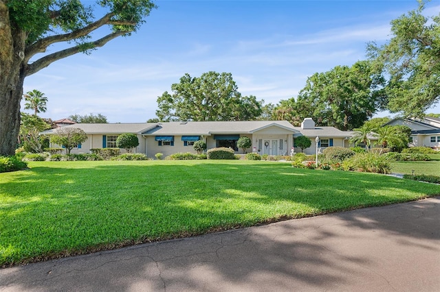 2110 Reaney Rd, Lakeland, FL 33803 - ranch-style home with a front yard and a chimney
