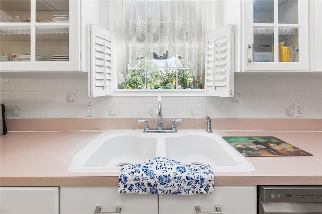 2110 Reaney Rd, Lakeland, FL 33803 - kitchen view of white cabinets, light countertops, stainless steel dishwasher, and backsplash