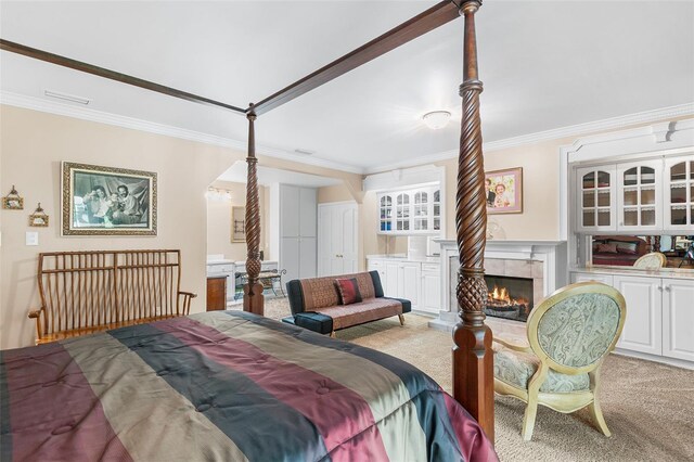 2110 Reaney Rd, Lakeland, FL 33803 - carpeted bedroom with ornamental molding and a tile fireplace