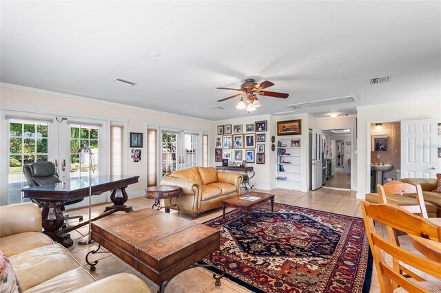 2110 Reaney Rd, Lakeland, FL 33803 - living area featuring french doors, a ceiling fan, attic access, light tile patterned floors, and crown molding