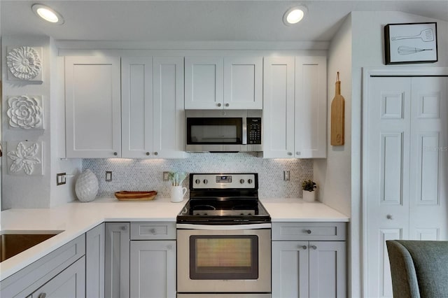 11728 Crest Creek Dr, Riverview, FL 33569 - kitchen featuring stainless steel appliances, tasteful backsplash, light countertops, white cabinetry, and recessed lighting