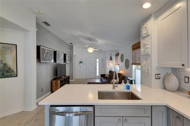 11728 Crest Creek Dr, Riverview, FL 33569 - kitchen featuring stainless steel dishwasher, a peninsula, light countertops, a sink, and lofted ceiling