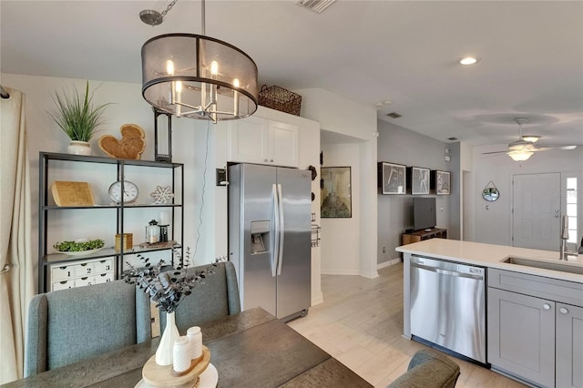 11728 Crest Creek Dr, Riverview, FL 33569 - kitchen featuring appliances with stainless steel finishes, a chandelier, baseboards, a sink, and ceiling fan