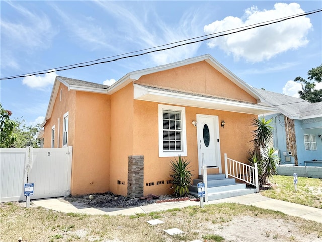 2137 W Saint Louis St, Tampa, FL 33607 - view of front of home with stucco siding and a gate
