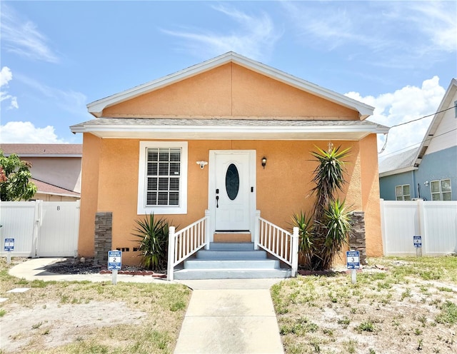 2137 W Saint Louis St, Tampa, FL 33607 - view of front of property featuring stucco siding and a gate