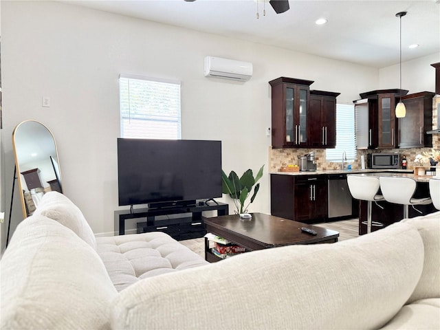 2137 W Saint Louis St, Tampa, FL 33607 - living area featuring a wall mounted AC, ceiling fan, recessed lighting, and light wood finished floors