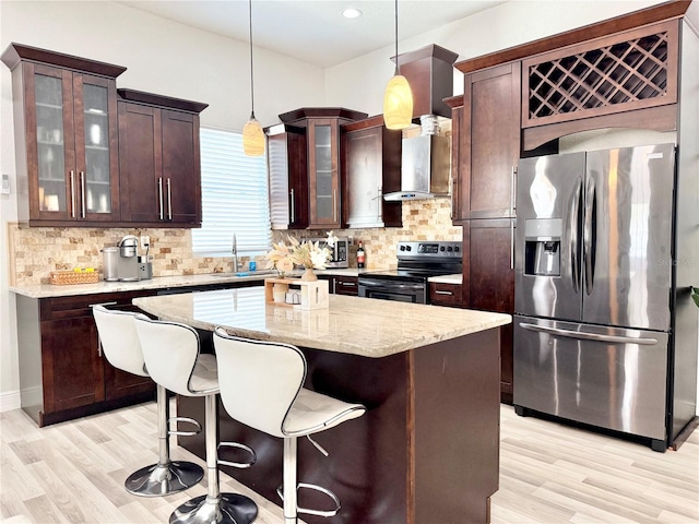 2137 W Saint Louis St, Tampa, FL 33607 - kitchen with stainless steel appliances, light wood-style floors, a sink, a center island, and recessed lighting