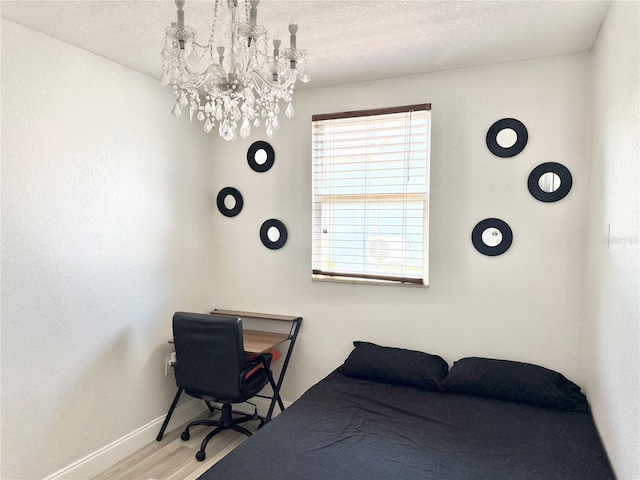 2137 W Saint Louis St, Tampa, FL 33607 - bedroom featuring a chandelier, wood finished floors, and baseboards
