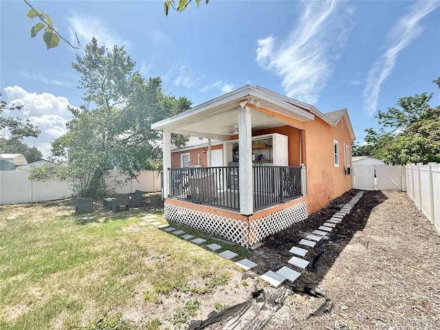2137 W Saint Louis St, Tampa, FL 33607 - rear view of house with ceiling fan, a gate, and stucco siding