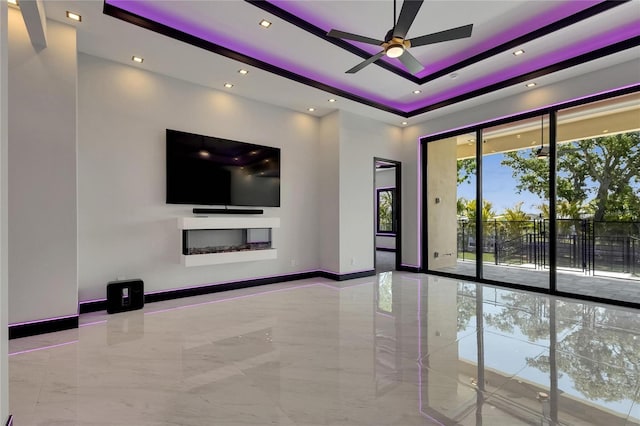 6532 Simone Shores Cir, Apollo Beach, FL 33572 - unfurnished living room with ceiling fan, a raised ceiling, baseboards, marble tiled floors, and recessed lighting