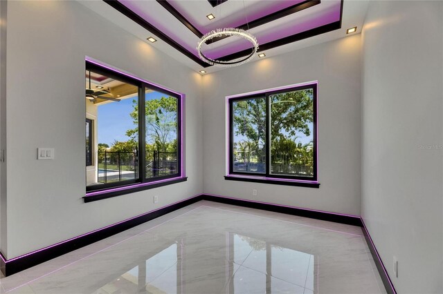 6532 Simone Shores Cir, Apollo Beach, FL 33572 - empty room featuring a raised ceiling, baseboards, a chandelier, and recessed lighting
