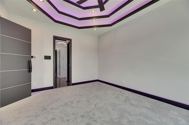 6532 Simone Shores Cir, Apollo Beach, FL 33572 - unfurnished bedroom with carpet flooring, a tray ceiling, baseboards, and recessed lighting