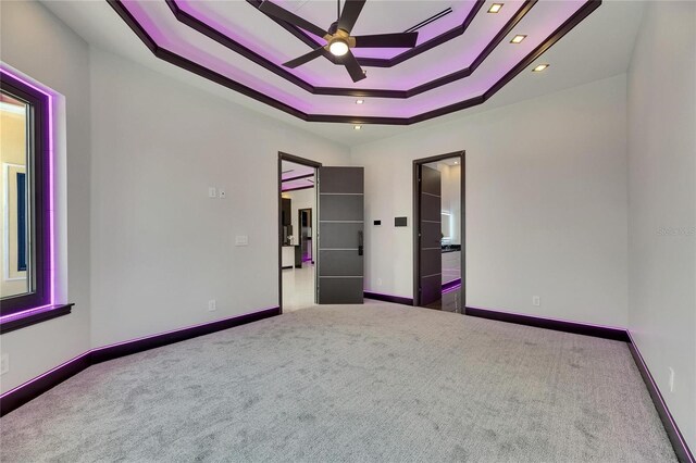 6532 Simone Shores Cir, Apollo Beach, FL 33572 - unfurnished bedroom featuring carpet, a tray ceiling, baseboards, and recessed lighting