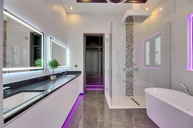 6532 Simone Shores Cir, Apollo Beach, FL 33572 - full bathroom featuring a stall shower, a freestanding bath, double vanity, and marble finish floors
