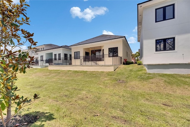 6532 Simone Shores Cir, Apollo Beach, FL 33572 - rear view of house featuring stucco siding, a yard, and a patio