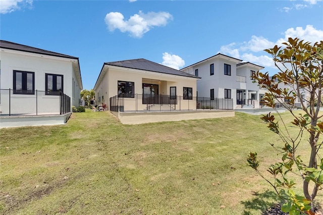 6532 Simone Shores Cir, Apollo Beach, FL 33572 - back of house with stucco siding and a lawn