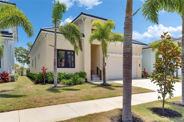 6532 Simone Shores Cir, Apollo Beach, FL 33572 - mediterranean / spanish home with stucco siding, driveway, an attached garage, and a front yard