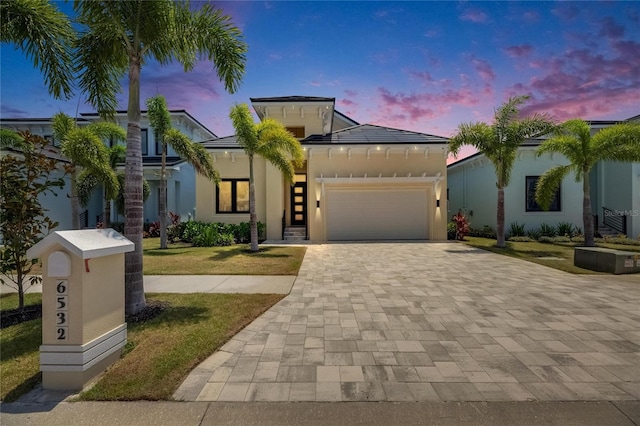 6532 Simone Shores Cir, Apollo Beach, FL 33572 - view of front facade featuring a garage, decorative driveway, a front yard, and stucco siding