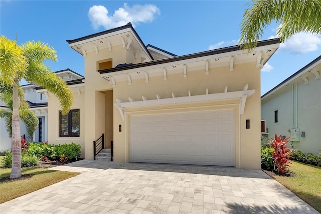 6532 Simone Shores Cir, Apollo Beach, FL 33572 - view of front of property with stucco siding, decorative driveway, and a garage