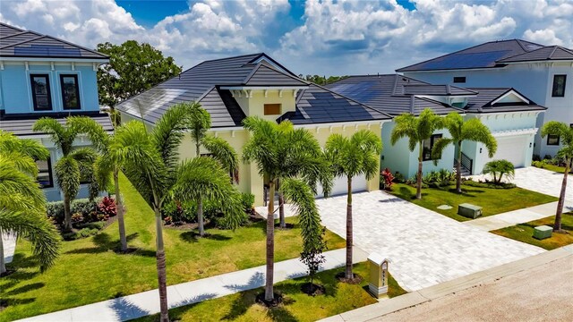 6532 Simone Shores Cir, Apollo Beach, FL 33572 - view of front of house with decorative driveway, a front yard, a garage, and stucco siding