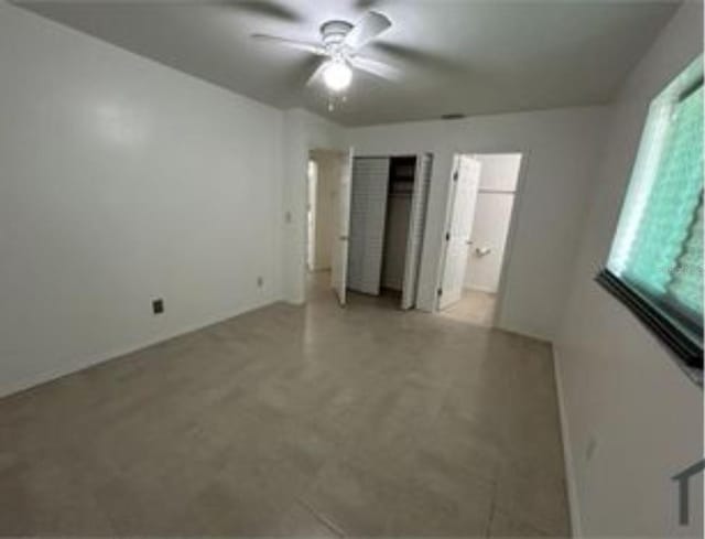 16599 Davis Rd Unit 16599, Fort Myers, FL 33908 - unfurnished bedroom with ensuite bathroom and ceiling fan