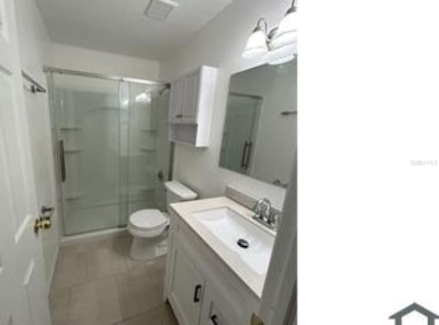 16599 Davis Rd Unit 16599, Fort Myers, FL 33908 - full bathroom with vanity, a shower stall, toilet, and tile patterned floors