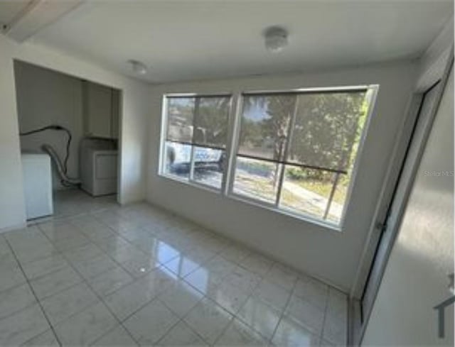 16599 Davis Rd Unit 16599, Fort Myers, FL 33908 - unfurnished dining area featuring plenty of natural light, light tile patterned floors, and washer / dryer