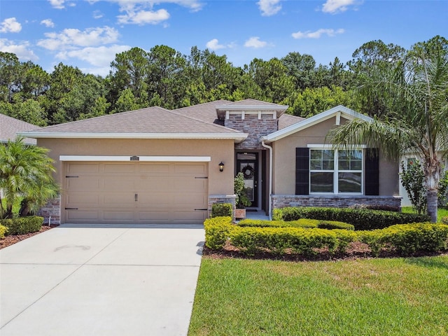 32825 Sand Creek Dr, Wesley Chapel, FL 33543 - view of front of home featuring stone siding, a garage, stucco siding, driveway, and a front lawn