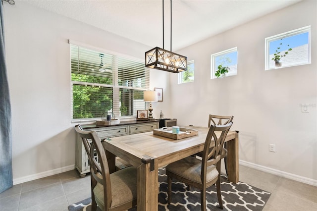 32825 Sand Creek Dr, Wesley Chapel, FL 33543 - dining space with light tile patterned floors and baseboards