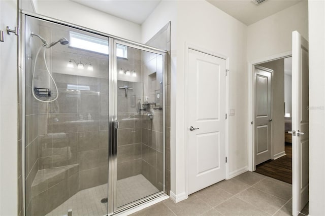 32825 Sand Creek Dr, Wesley Chapel, FL 33543 - full bathroom with a stall shower, tile patterned floors, and baseboards