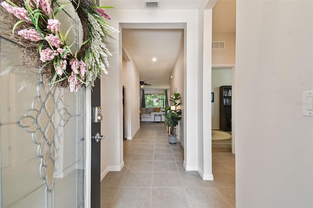 32825 Sand Creek Dr, Wesley Chapel, FL 33543 - foyer entrance with light tile patterned flooring, baseboards, and ceiling fan