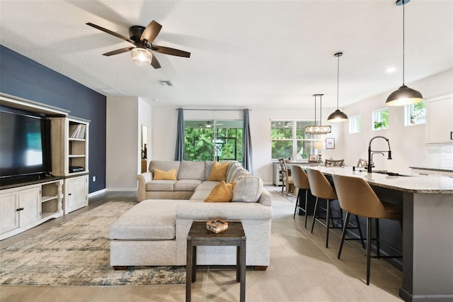 32825 Sand Creek Dr, Wesley Chapel, FL 33543 - living area with ceiling fan and baseboards