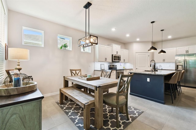 32825 Sand Creek Dr, Wesley Chapel, FL 33543 - dining room with light tile patterned floors, recessed lighting, and baseboards