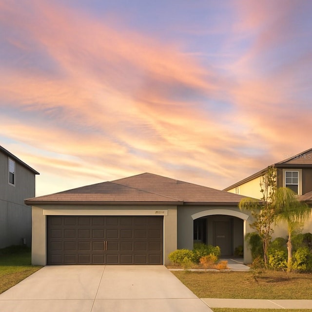 16725 Delia St, Wimauma, FL 33598 - view of front of home with driveway, a garage, and stucco siding