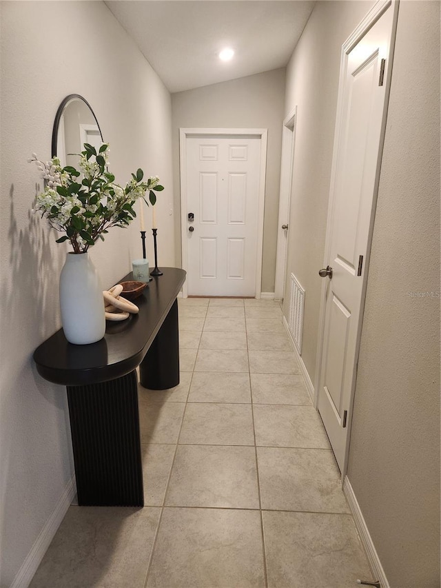 16725 Delia St, Wimauma, FL 33598 - corridor featuring light tile patterned flooring and baseboards